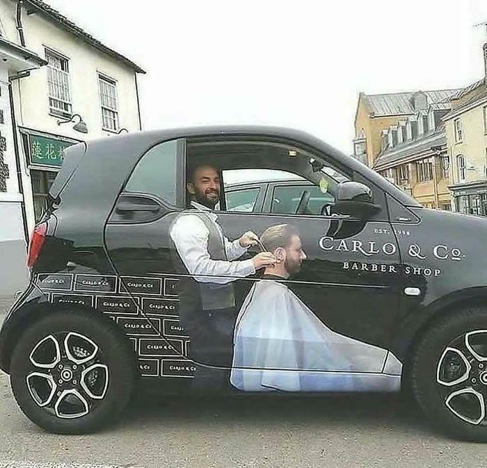 Barber shop car wrap creates optical illusion of a man getting a haircut, making viewers go 'hmmm'.