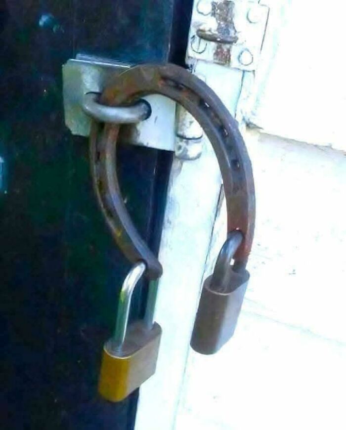 A door latch using a horseshoe secured with two padlocks, making it an unusual sight that made people go 'hmmm'.