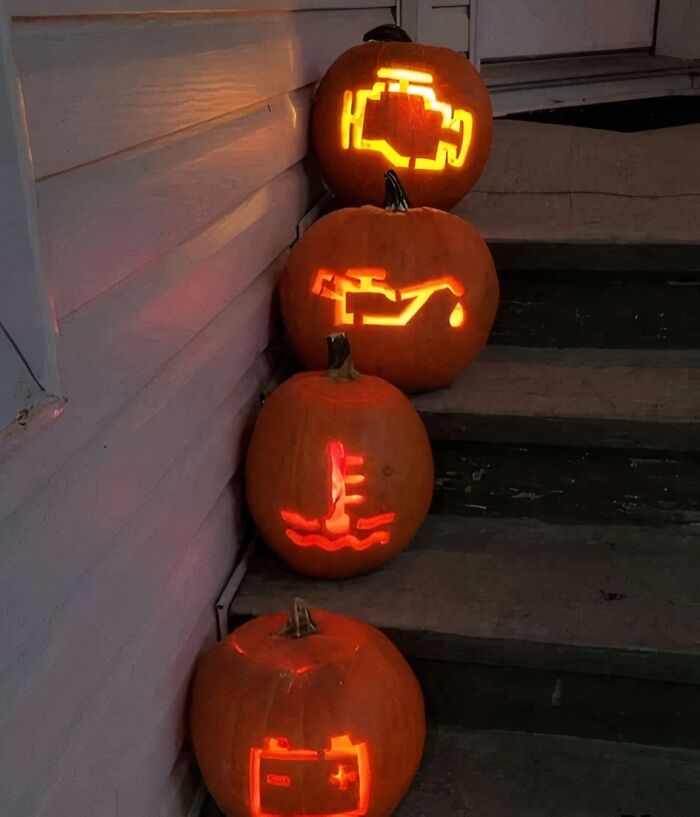 Pumpkins on steps carved with car warning lights, capturing a 'hmmm' moment.