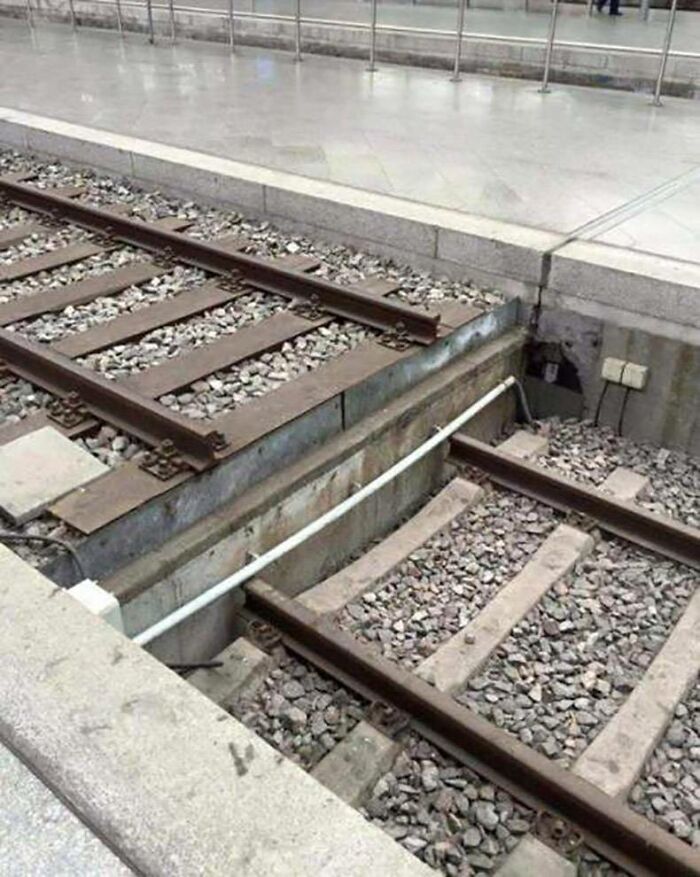 Train tracks abruptly ending, leading to a puzzling sight that makes you go 'hmmm'.